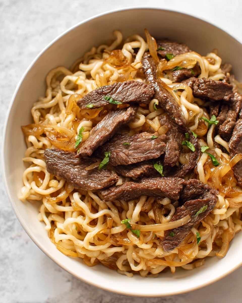 A white bowl filled with light beige cooked noodles forming the base layer, mixed with caramelized translucent brown onion slices. Scattered on top are medium-sized, dark brown grilled beef strips with a slightly shiny texture. Small pieces of green herbs are sprinkled throughout as a garnish, adding a touch of color contrast. The noodles appear soft and slightly glossy, intertwined with the beef and onions. The bowl sits on a white marbled surface with soft natural lighting highlighting the textures and colors of the dish. photo taken with an iphone --ar 4:5 --v 7