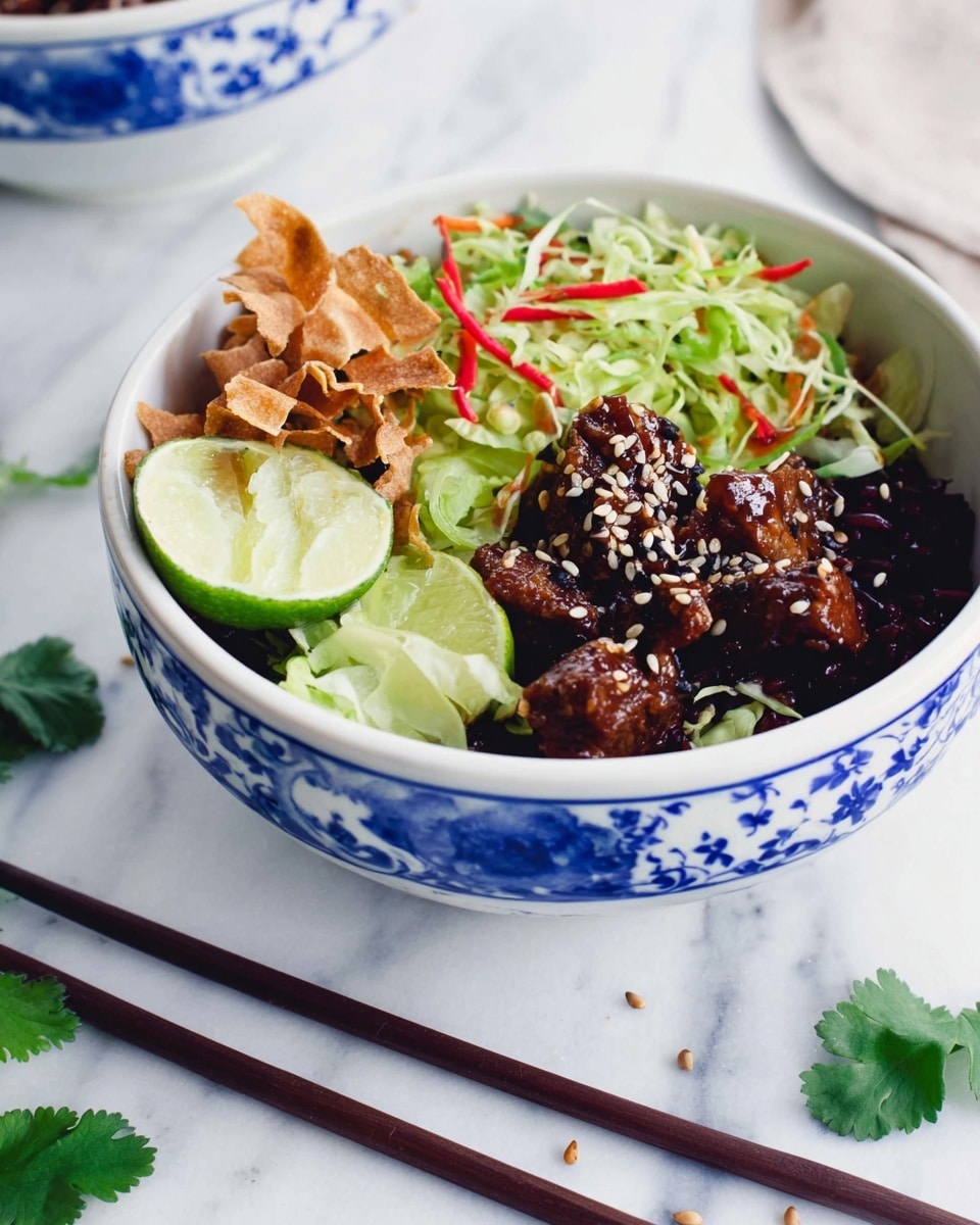 A white bowl with blue floral patterns holds a colorful layered dish. The bottom layer is dark rice or grains, topped with a mix of crunchy light brown crispy strips on one side. Next to it, there is a fresh green salad made of shredded lettuce and thin red and green vegetable strips. The center layer features glazed dark brown meat chunks sprinkled with white and black sesame seeds. A wedge of light green lime is placed on the side for garnish. The bowl rests on a white marbled surface with some scattered green cilantro leaves and sesame seeds nearby, plus two dark brown wooden chopsticks lie beside it. Photo taken with an iphone --ar 4:5 --v 7